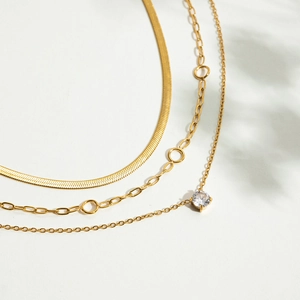 Three-layer gold stainless steel necklace set featuring snake chain and zircon pendant