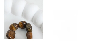 Macro shot of tiger eye beads showing natural cat-eye effect and polished texture