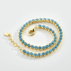 Close-up of S925 sterling silver gold bracelet with micro-pave blue turquoise stones