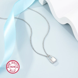 Solid S925 sterling silver padlock necklace on elegant blue background with silk ribbon