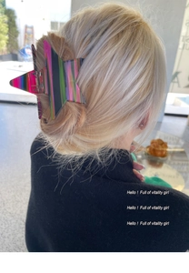 Detailed view of iridescent star-shaped hair claw clip on blonde hair in soft indoor light