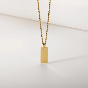 Minimalist gold stainless steel rectangle pendant with rope chain on a white background