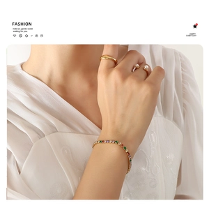 Elegant multi-color zircon tennis bracelet and pearl rings on a model's hand