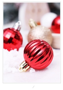 Macro view of textured red and gold Christmas ornaments with festive snowflake lighting