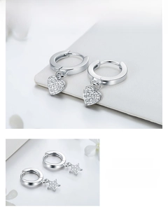 Detail of S925 sterling silver hoop earrings with zircon heart and star pendants