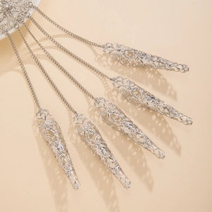 Dettaglio di cinque anelli in argento con catene e nappine a cono da donna elegante