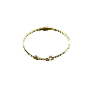 Chic gold-tone bangle bracelet featuring a central LOVE motif set with sparkling crystals