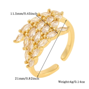 Detailed macro view of gold feather ring with marquise zircon stones and 11.5mm width dimensions