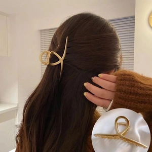 Elegant gold metal hair claw clip with cross design for women in matte finish style