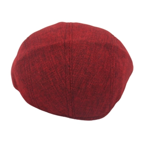 Close-up of deep red textured tweed flat cap showing classic vintage fabric weave details