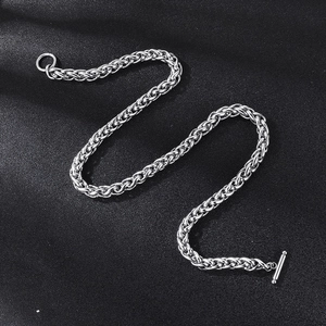 Detail of silver stainless steel basket chain with OT toggle clasp on black leather background