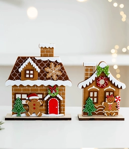 Detail of Christmas felt gingerbread houses with wooden bases and festive trees