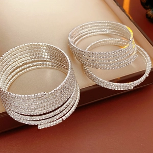 Macro shot of silver multi-layer spiral rhinestone bracelets inside a premium jewelry box