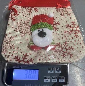 Detail showing the 38g lightweight Christmas drawstring gift bag with 3D plush cartoon decor