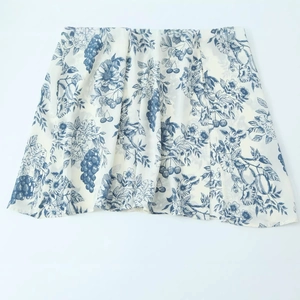 Square neck slim dress with blue floral print and side slit in long sleeve style
