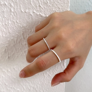 Macro detail of minimalist S925 sterling silver rings with textured vertical lines