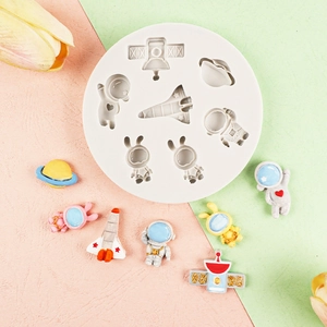 Space-themed silicone mold with astronaut and rocket shapes for creative cake decorating