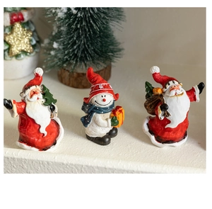 Detailed macro view of resin Santa and snowman figurines for Christmas tabletop decor