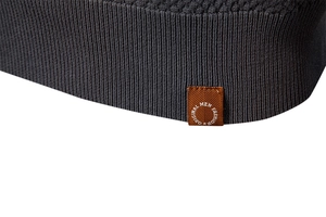 Detailed macro view of dark grey pineapple knit texture and premium stitching on polo shirt