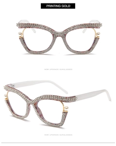 Detail view of gold cat-eye glasses frame with crystal rhinestones and pearl embellishments