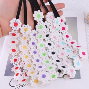 Detailed embroidery of daisy lace headbands in various colors with elastic bands