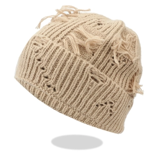 Distressed beige knit beanie with ripped details and fringes in streetwear style
