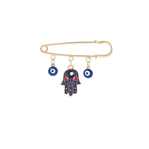 Golden evil eye brooch with hamsa hand and blue evil eye charms on white background