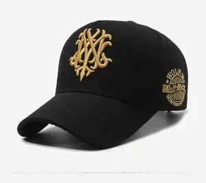 Detail view of black baseball cap featuring 3D gold embroidery and a circular side patch