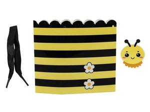 Detail view of bee theme party favor box with yellow stripes, black ribbon and stickers