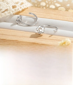 Detail of silver star C-shaped hoop earring on display with 0.8mm copper wire coil