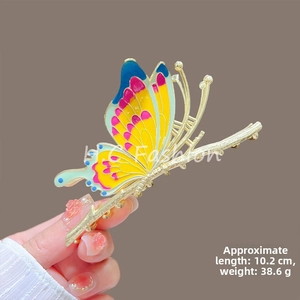 Detail shot of large gold butterfly hair claw with colorful enamel wings and size specs