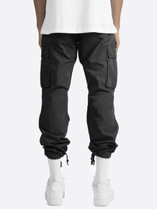 Rear view of black cargo trousers showing multi-pocket design and drawstring hem detail