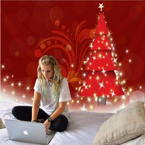 Detail of red Christmas wall tapestry with abstract gold star tree in a bedroom setting