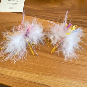 Exquisite handmade white feather earrings with dried pink flowers and gold bead accents