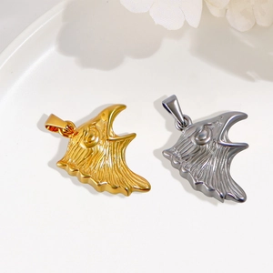 Detailed view of 24K gold and silver eagle head pendants for necklace jewelry making