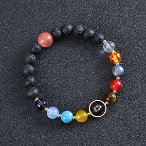 Close-up of lava rock bracelet with Aquarius zodiac bead and colorful galaxy stones