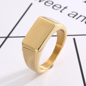 Detailed close-up of a minimalist gold rectangle signet ring made of polished stainless steel