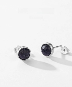 Detail view of S925 sterling silver studs with faceted dark blue starstone gems