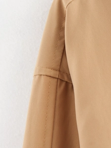 Detailed close-up of khaki flight jacket shoulder seams and premium stitching quality