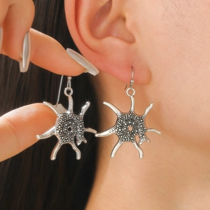 Silver vintage sunburst drop earrings with textured relief and a rustic industrial finish