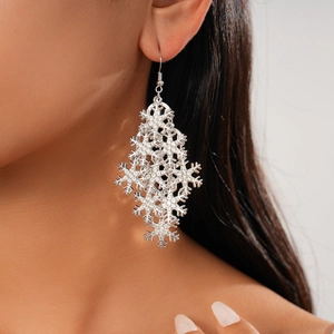 Elegant silver snowflake drop earrings with rhinestones on a female model for parties