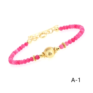 Detail of rose red carnelian beaded bracelet with gold plated beads and lobster clasp