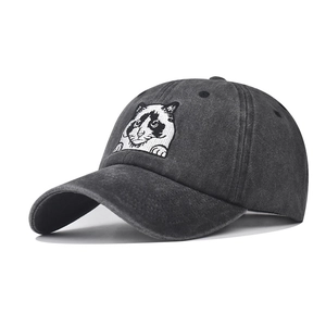 Detailed embroidery of a peeking cat on a washed charcoal cotton vintage baseball cap