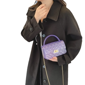 Chic purple jelly crossbody bag with quilted texture and gold chain strap on model