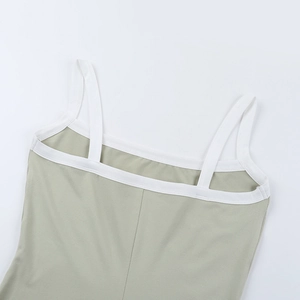 Detail of light green knit dress featuring white contrast piping and dual shoulder straps