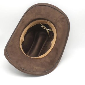 Detail view of dark brown faux suede cowboy hat interior with golden tie and material label