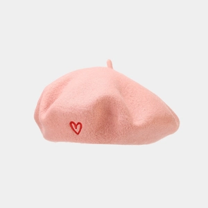 Detailed view of pink wool beret with heart embroidery and high-quality fabric texture