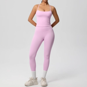 Close-up of pink high-waist yoga leggings and thin strap sports bra set for women