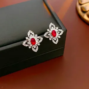 Silver flower stud earrings with red oval zirconia and sparkling micro-pave crystals