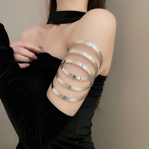 Close-up of silver multilayer arm cuff with hammered texture on a model's arm